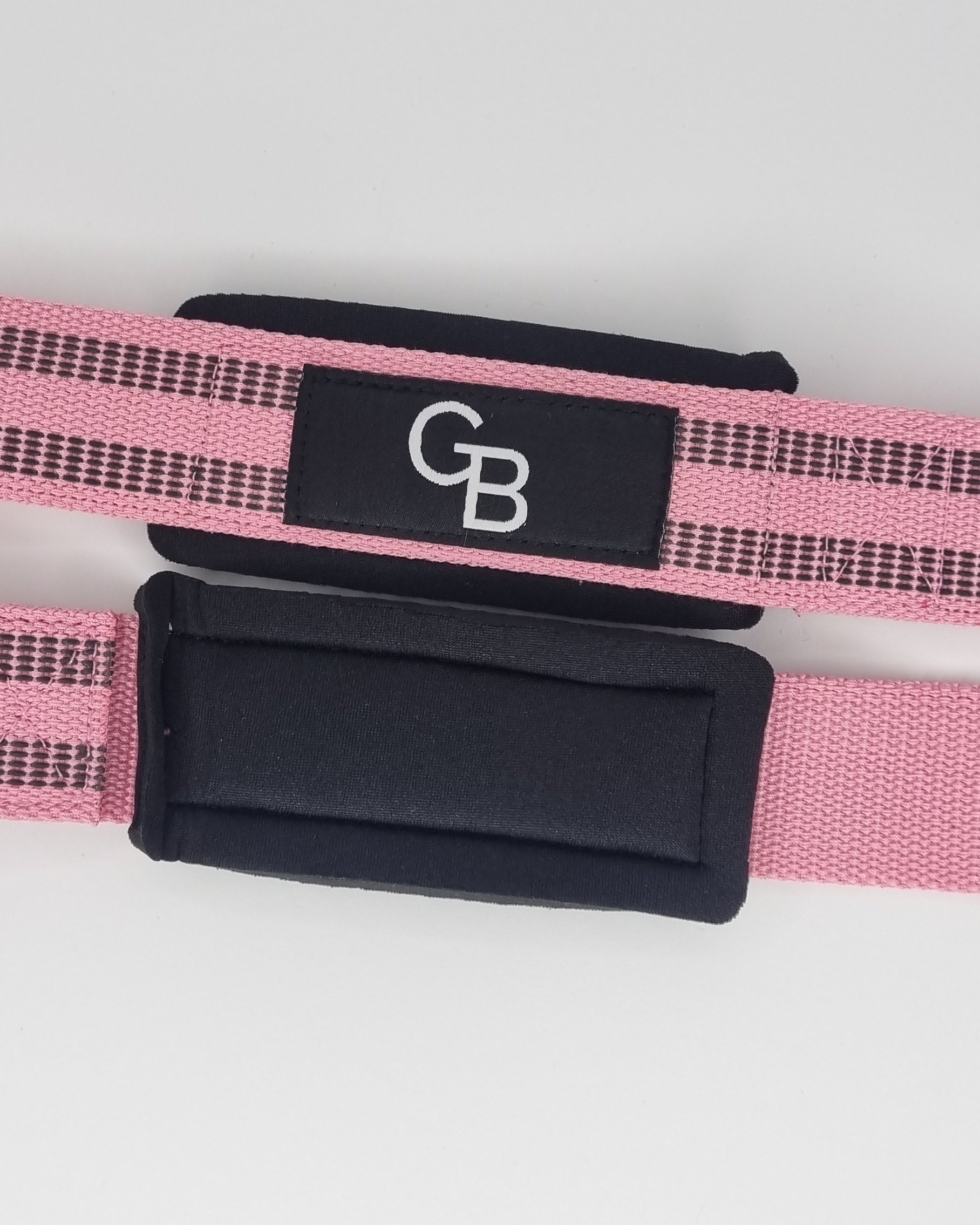 Pink and black lifting strap with 'GB' logo on a light gray background